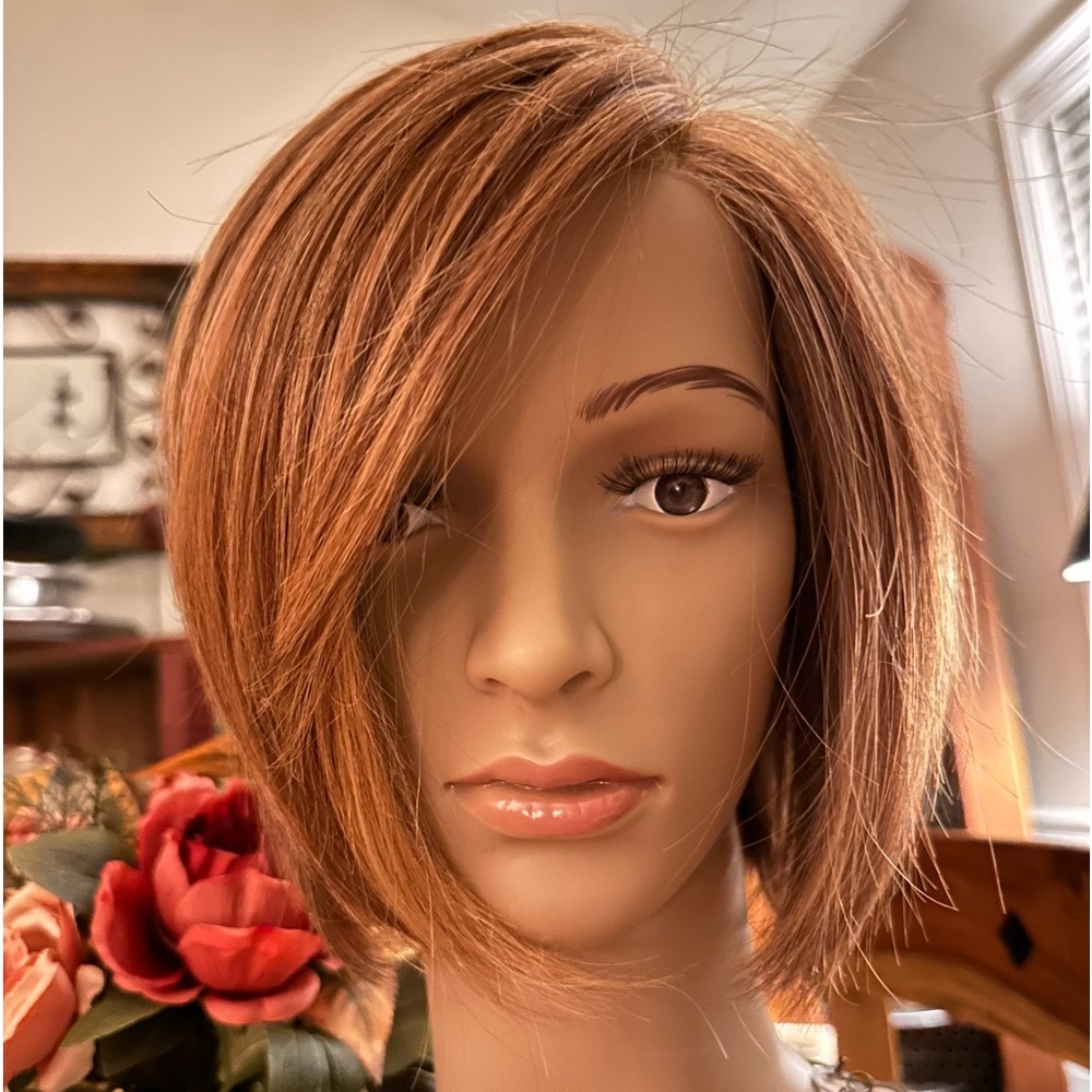 Raquel Welch Straight up with a twist wig.